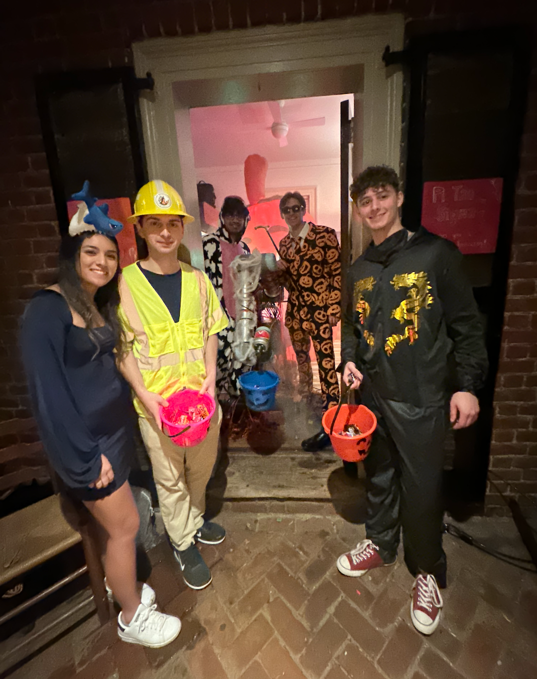 Pictured from left to right: Kristen, Nicholas, Taha, Dylan, & Owen alongside the trick or treating robot.